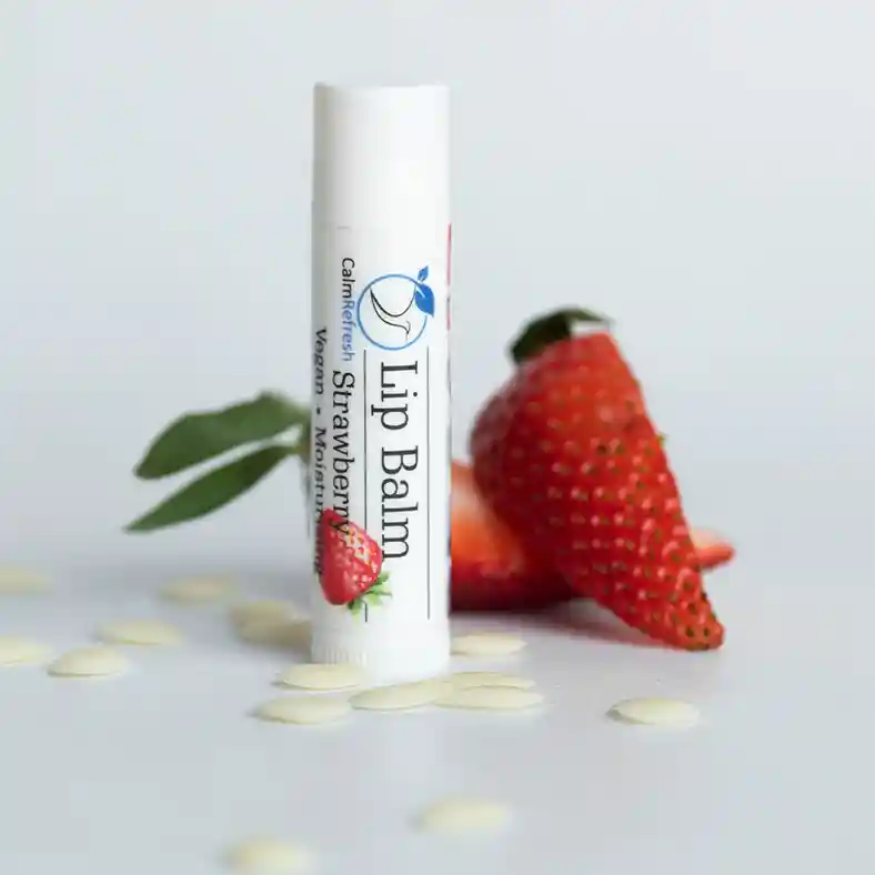 Strawberry Lip Balm surrounded by strawberries